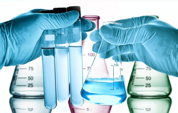 lab-technician-beakers-chemicals-gloves